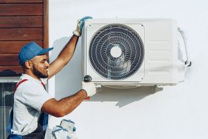 HVAC tech working on AC system