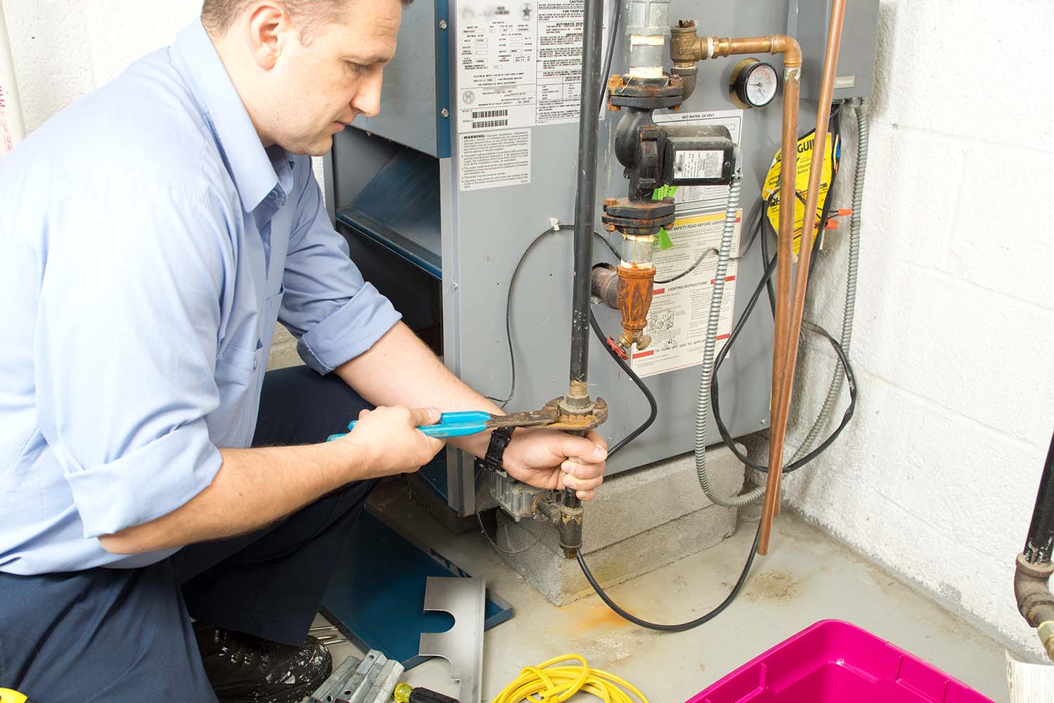 an HVAC technician fixing a furnace