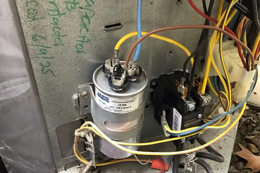 Air conditioner capacitor replacement in progress
