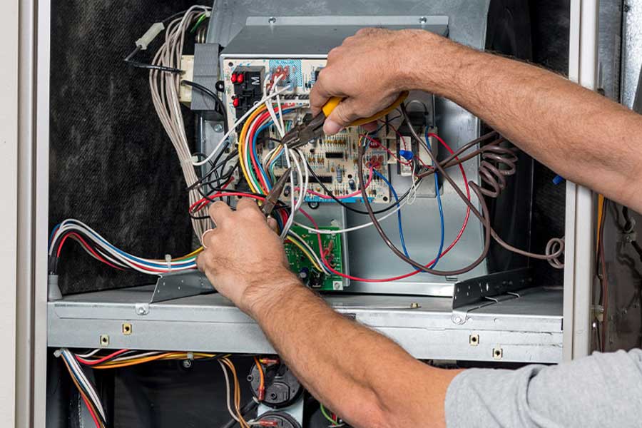 Technician performing furnace maintenance