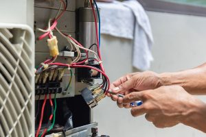 Furnace repair technician at work