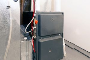Newly installed gas furnace with gas shutoff valve and sheet metal ductwork in a home basement