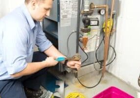 an HVAC technician fixing a furnace