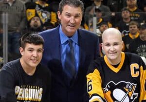 mario lemeiux with children wearing Pittsburgh Penguin jerseys